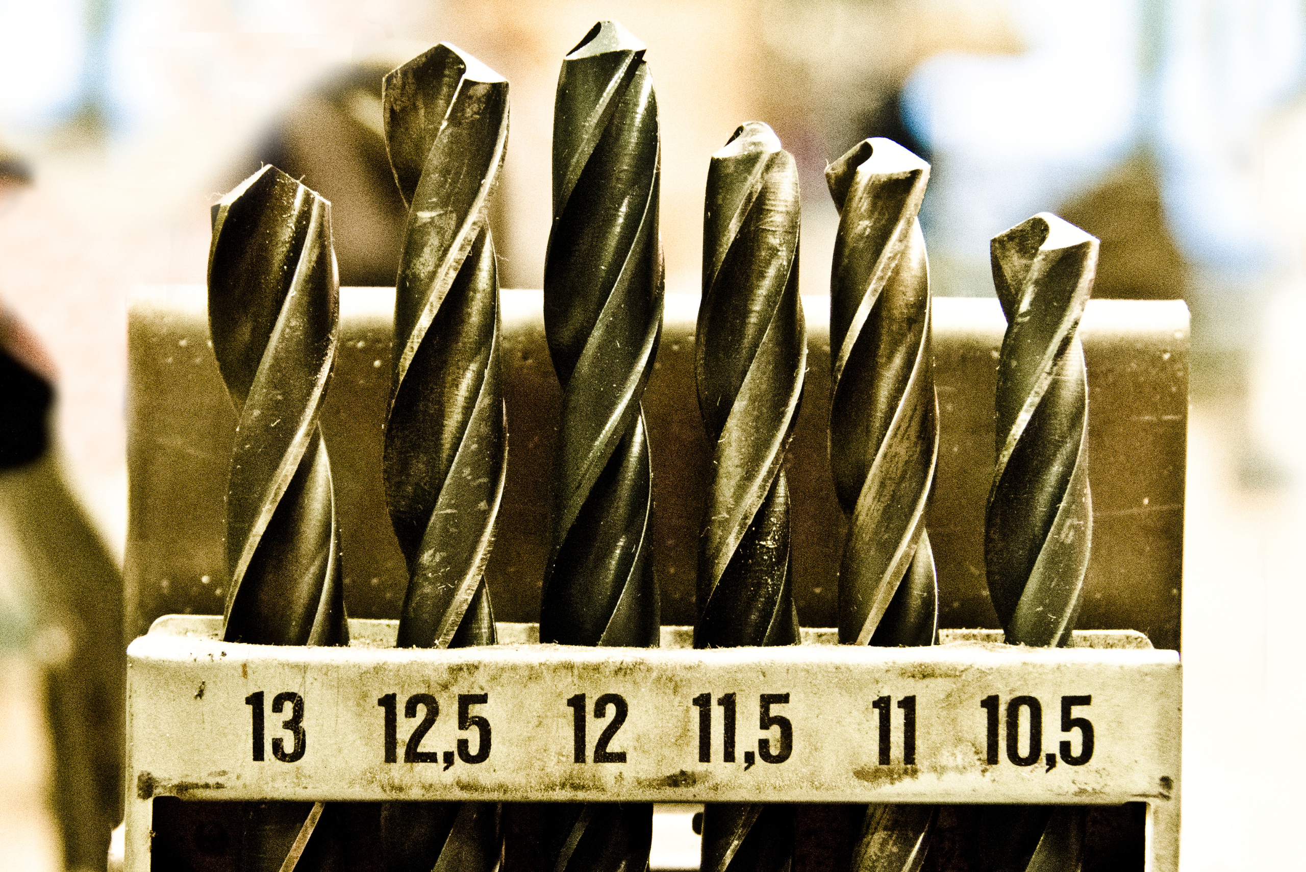 Drill bits in a wooden holder.