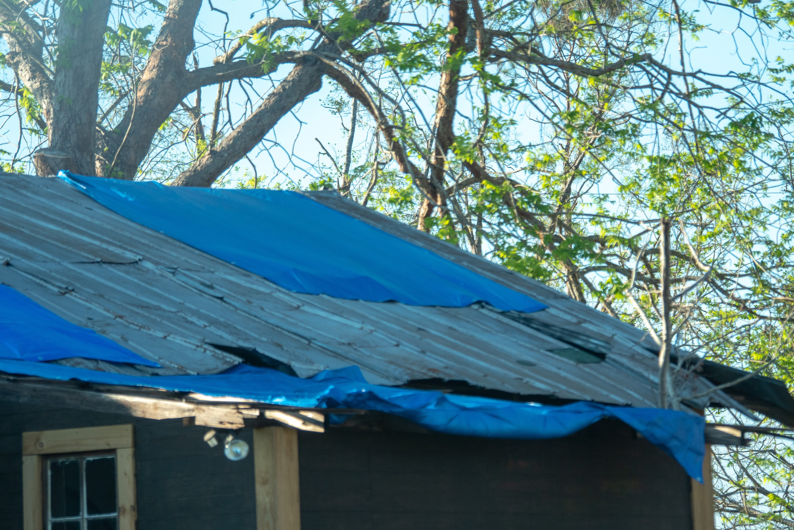 Blue tarp on roof.