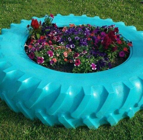 Painted tire with flower inside of it.