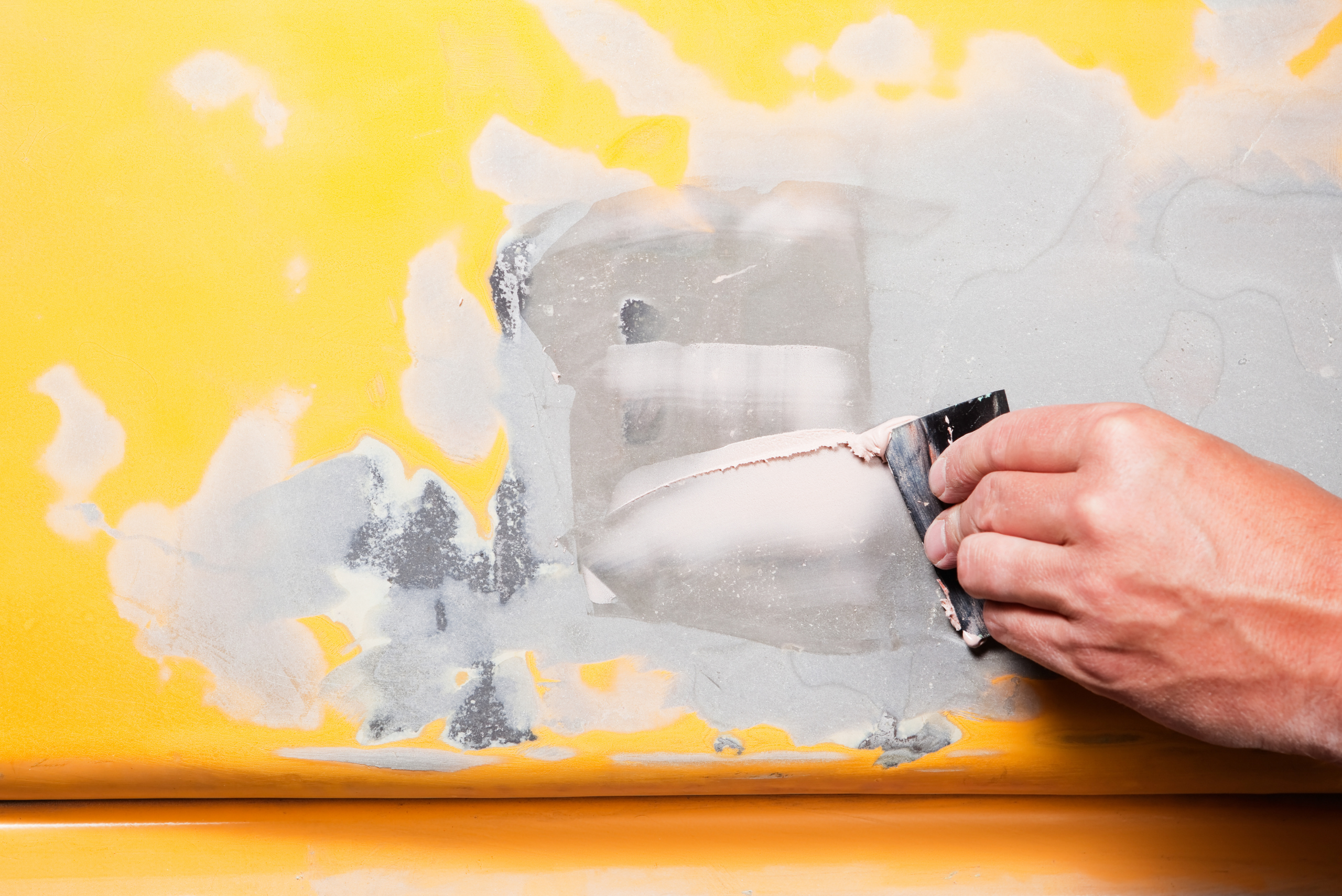 Bondo repair on a yellow car.