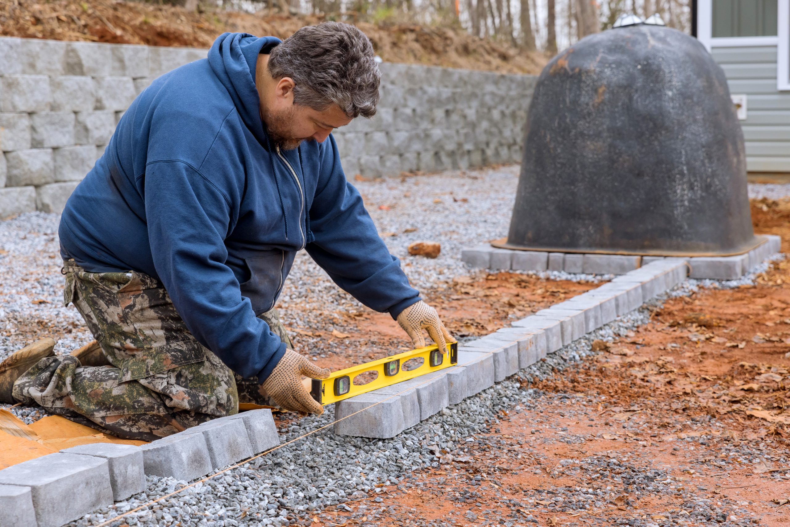 Man levelling concrete pavers.