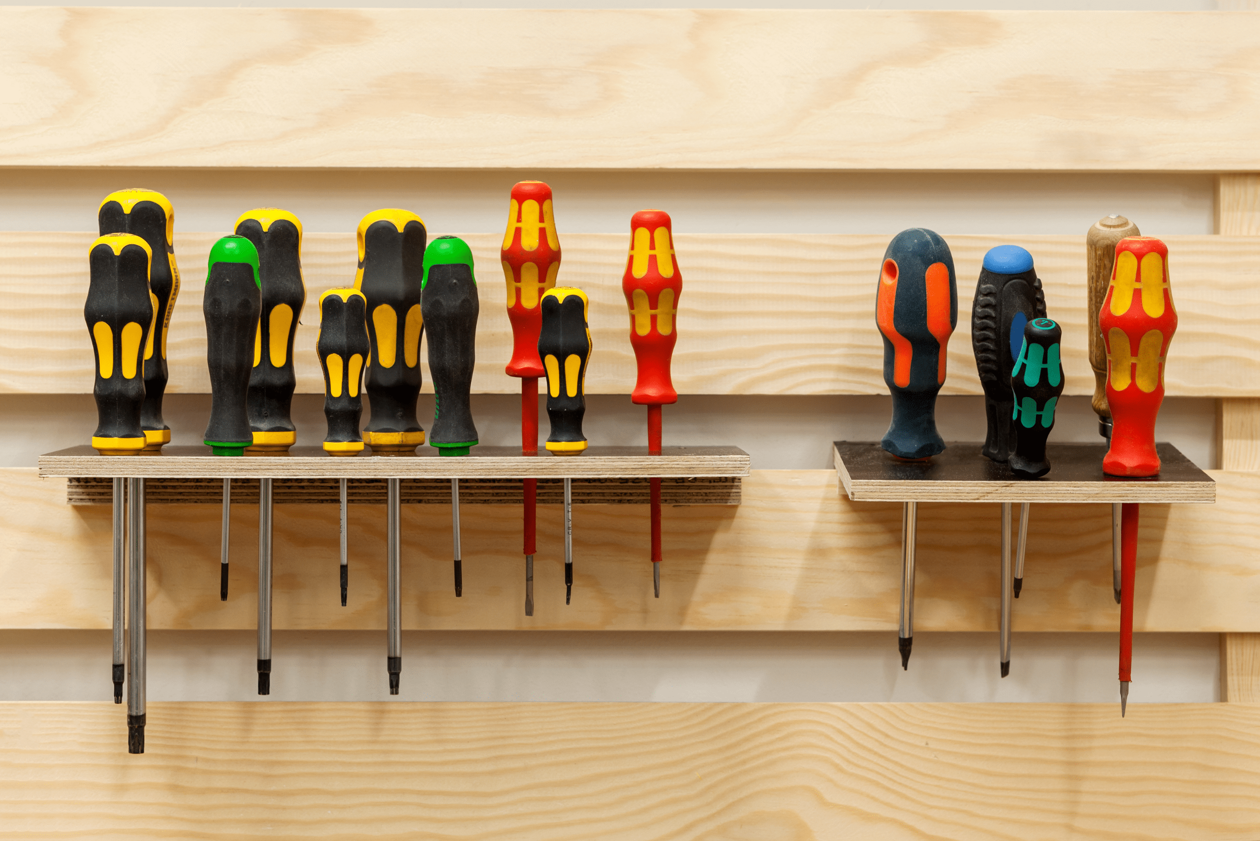 Screwdrivers mounted onto a wall holder.