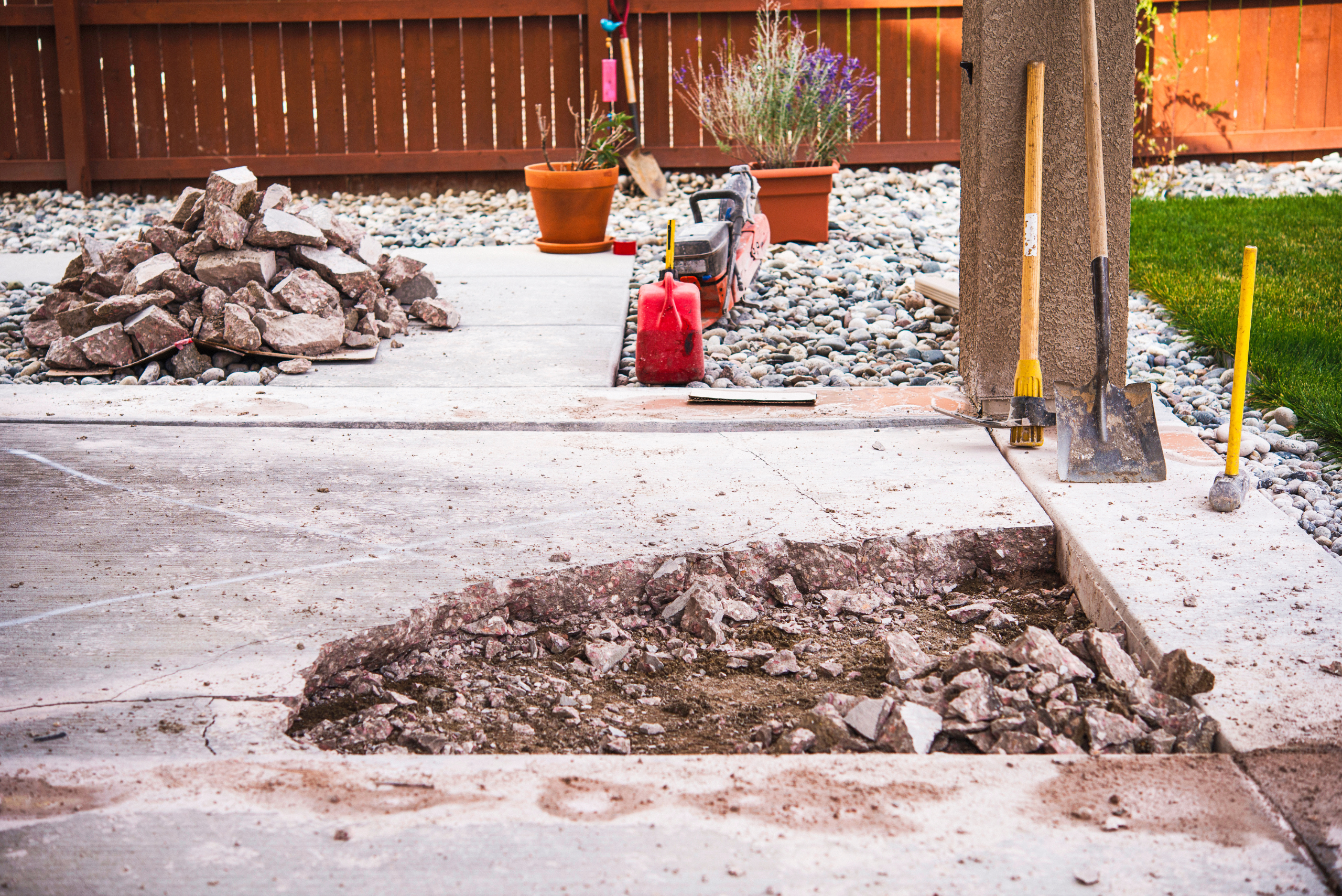 Patio stones torn up to install new ones that are leveled.