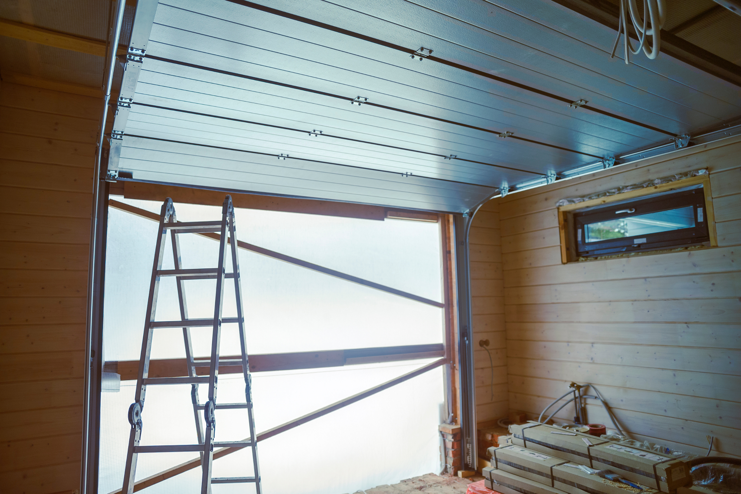 Garage door open with ladder.