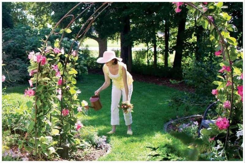 Woman watering garden.