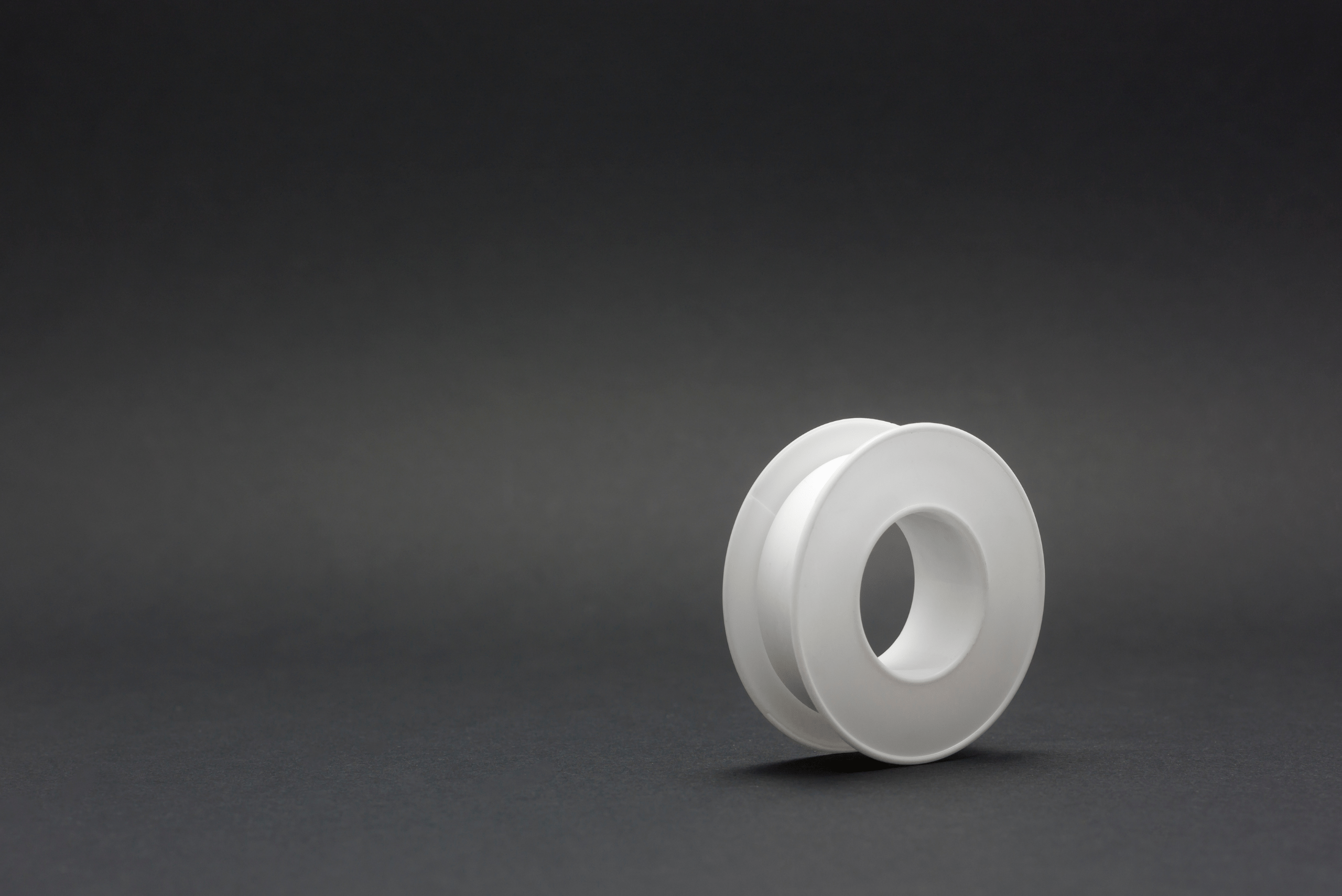 Teflon tape on black background.