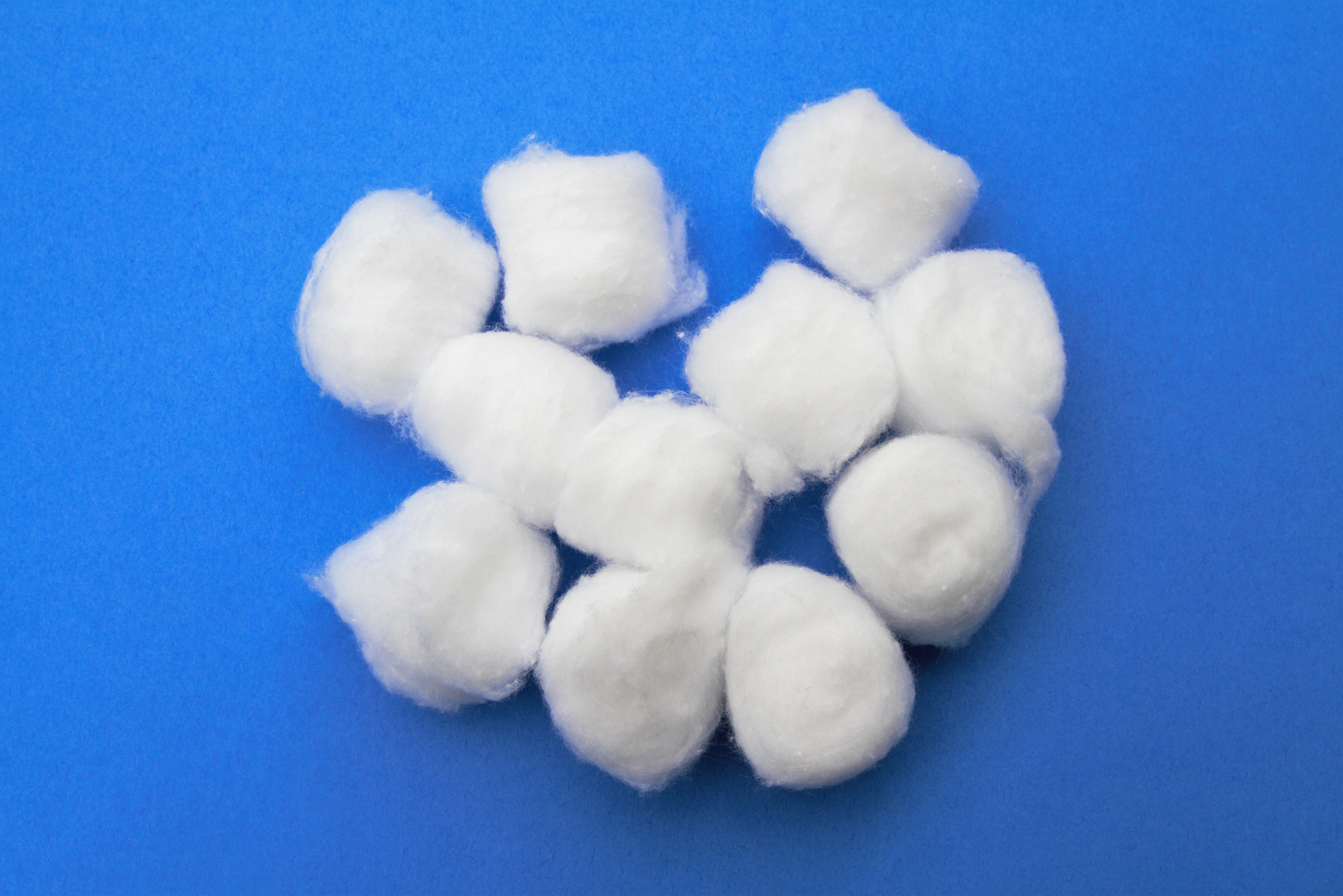 Cotton balls on blue background