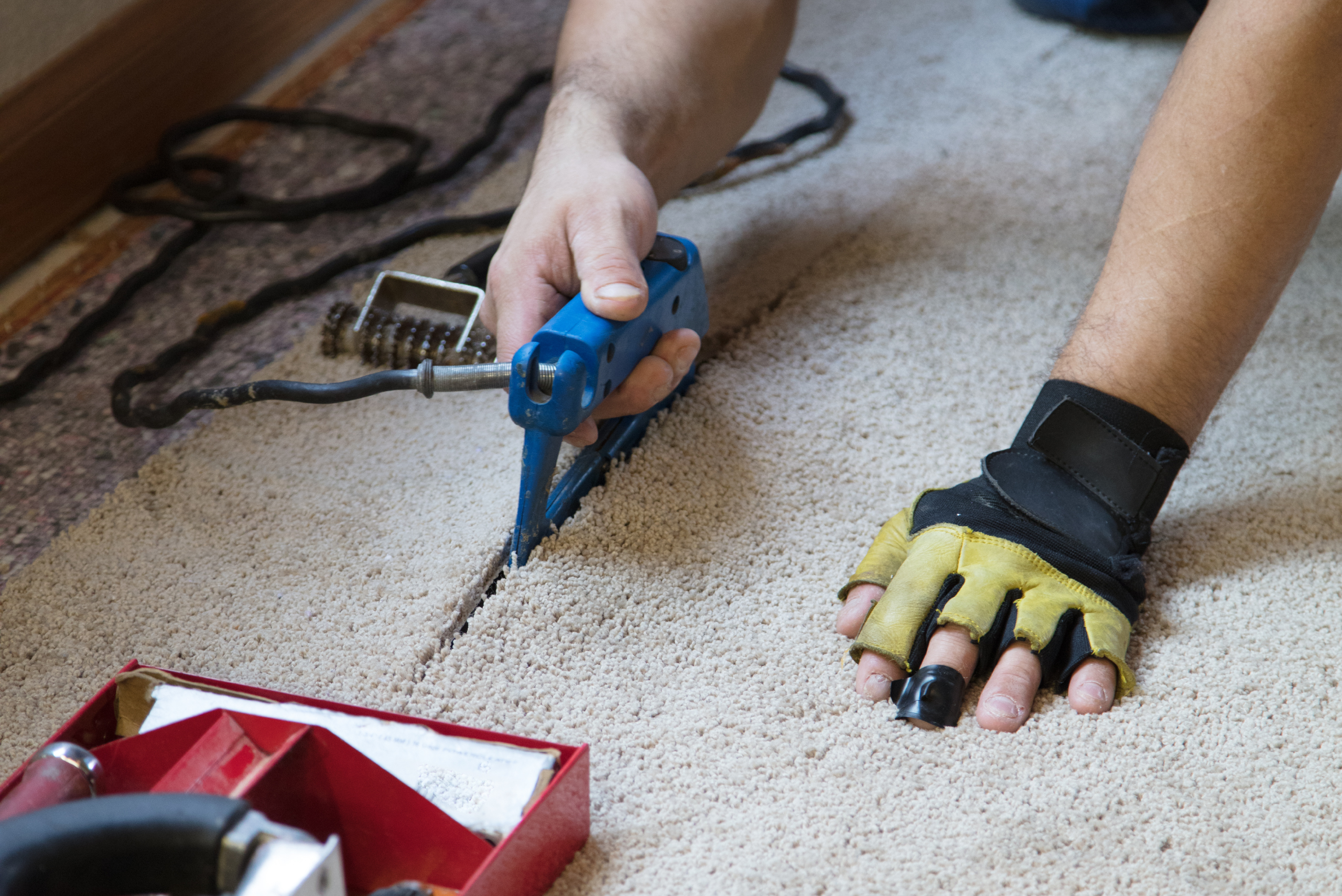 Gluing carpet with tool.