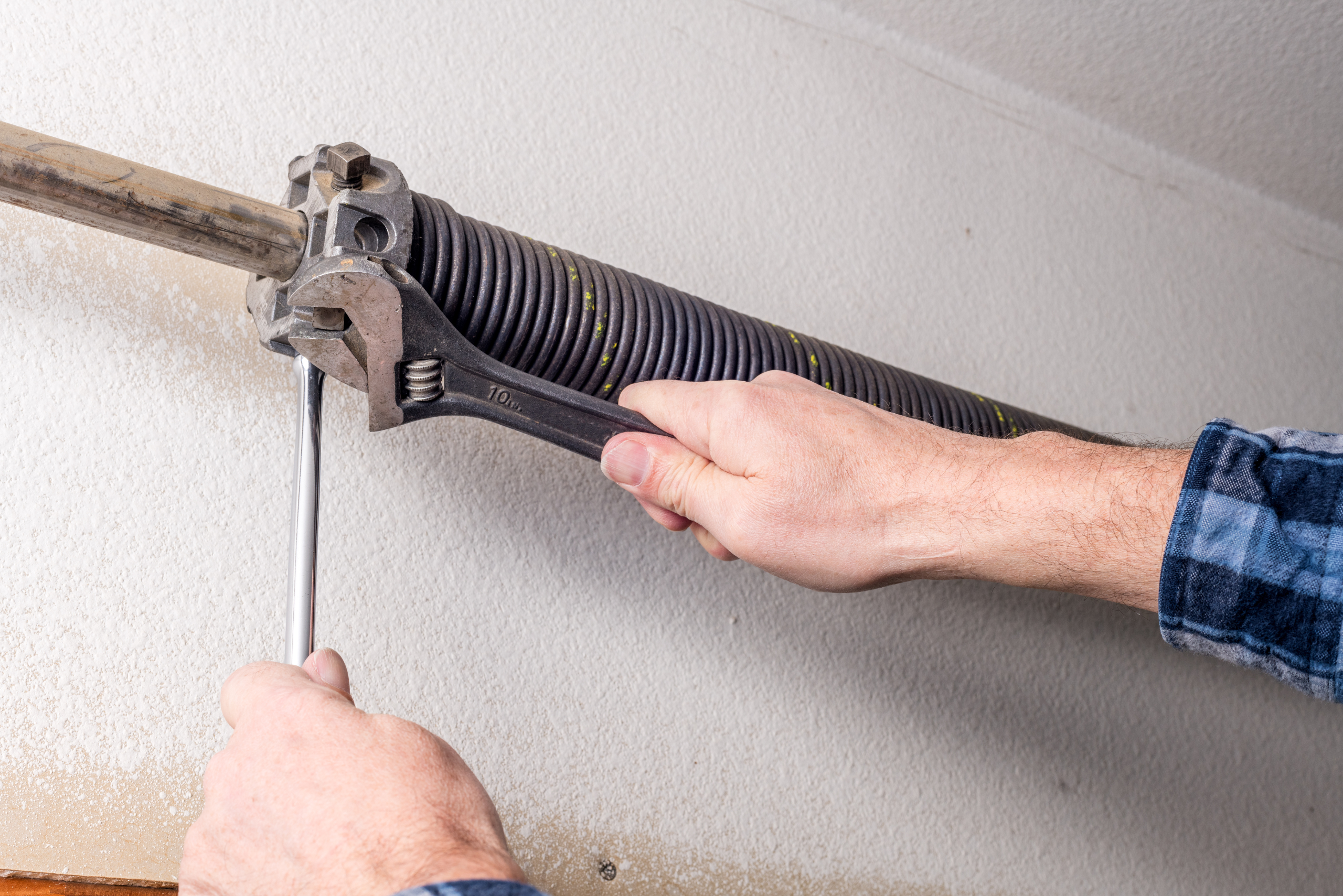 Adjusting garage door mechanism. 