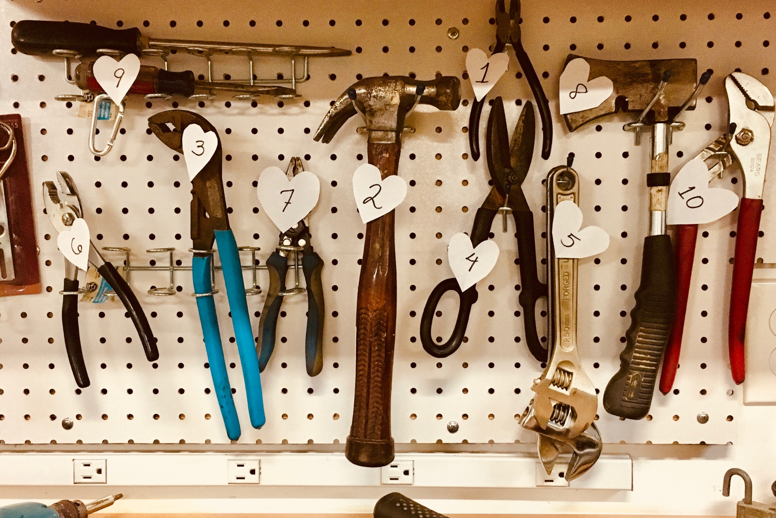 Tools organized on a pegboard.