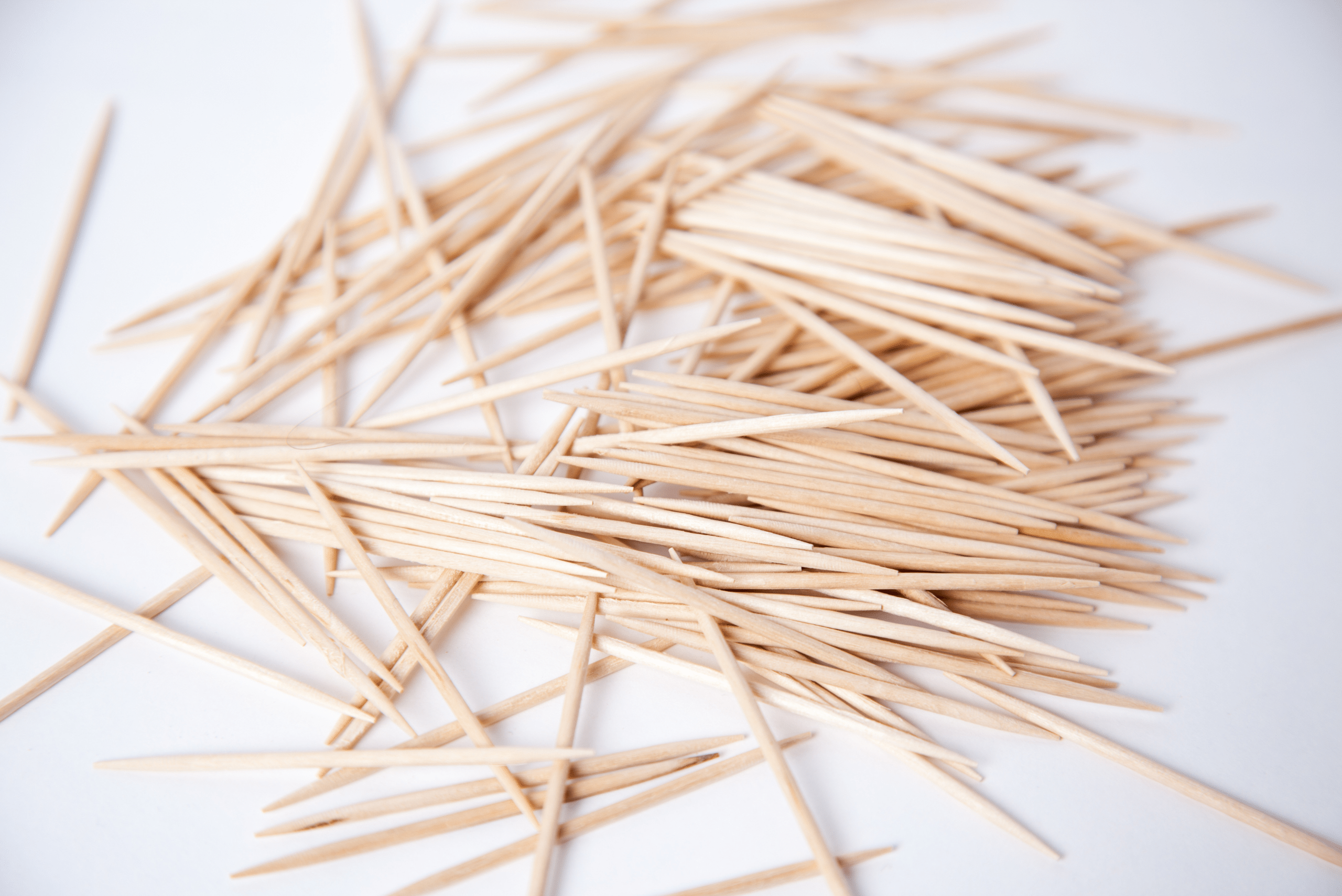 Bunch of toothpicks on a white background.