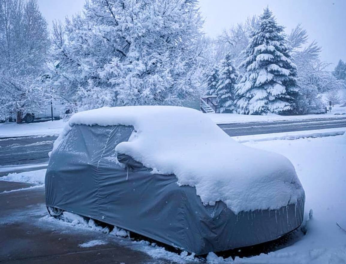 Car under cover in the snow.