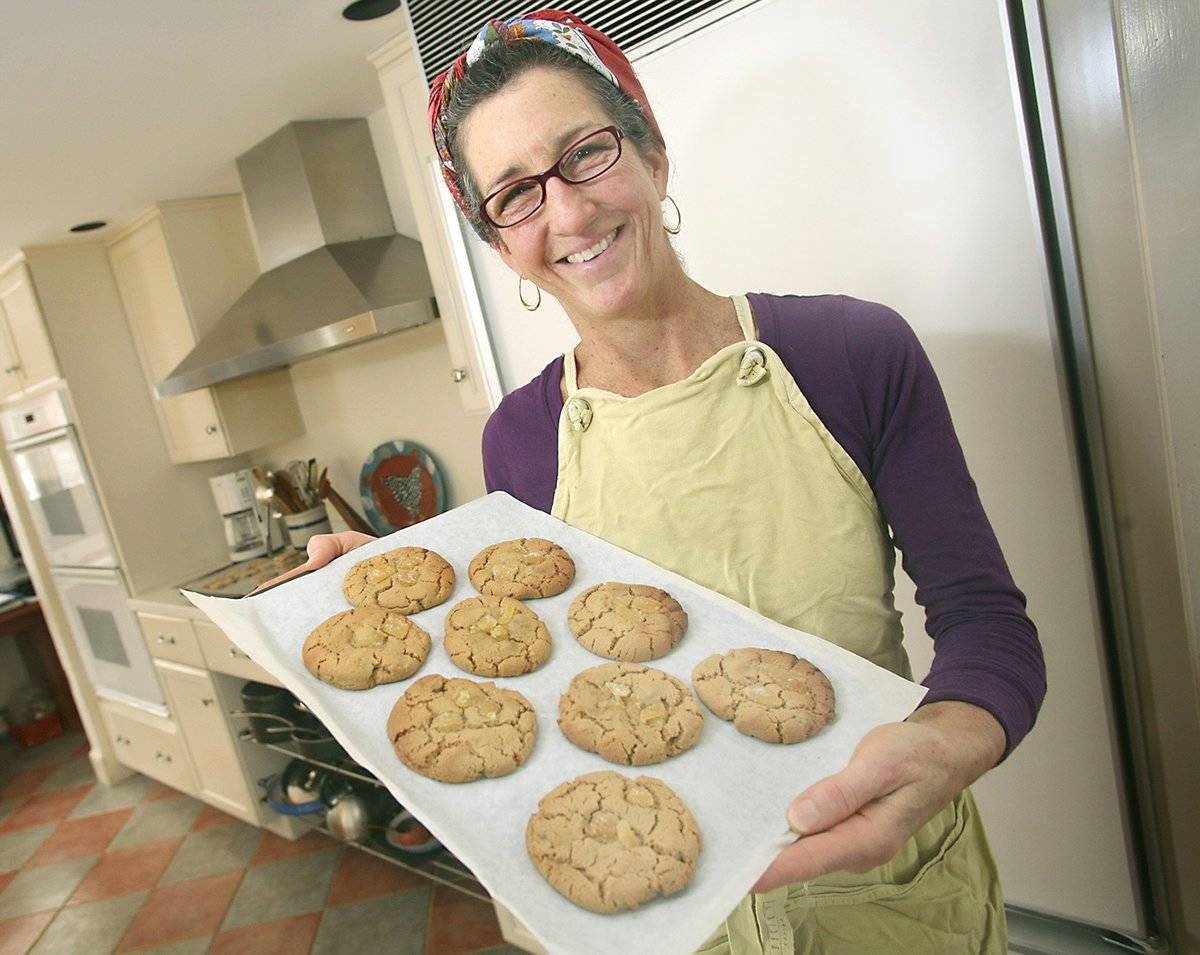 Woman holding a tray of cookies.