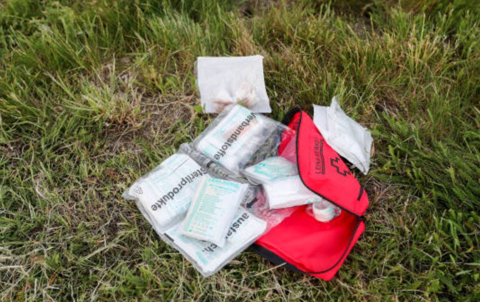 Emergency roadside kit on grass.