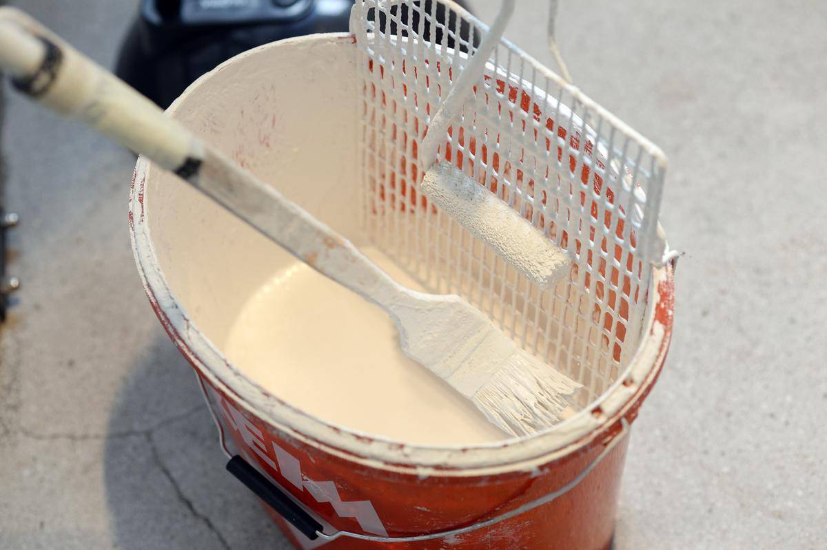 White paint bucket and brush.