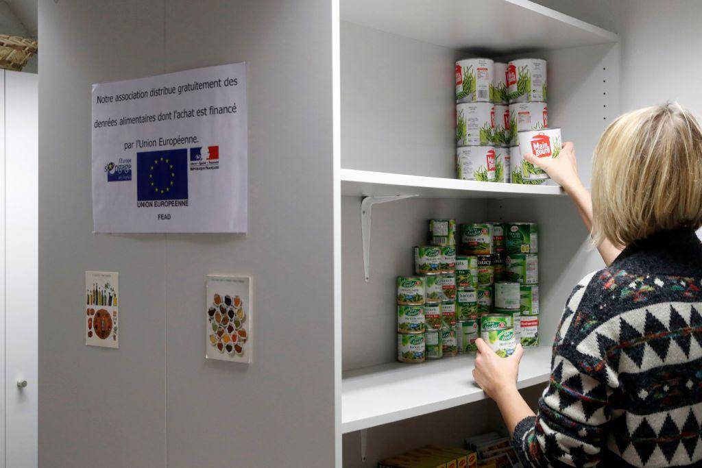 Woman stacking cans of food.