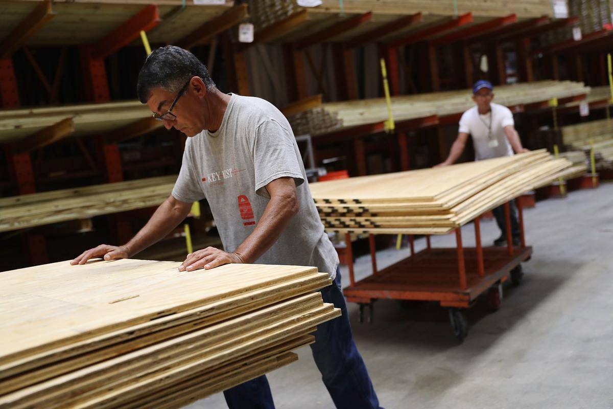 Man rolling out wood from Home Depot.