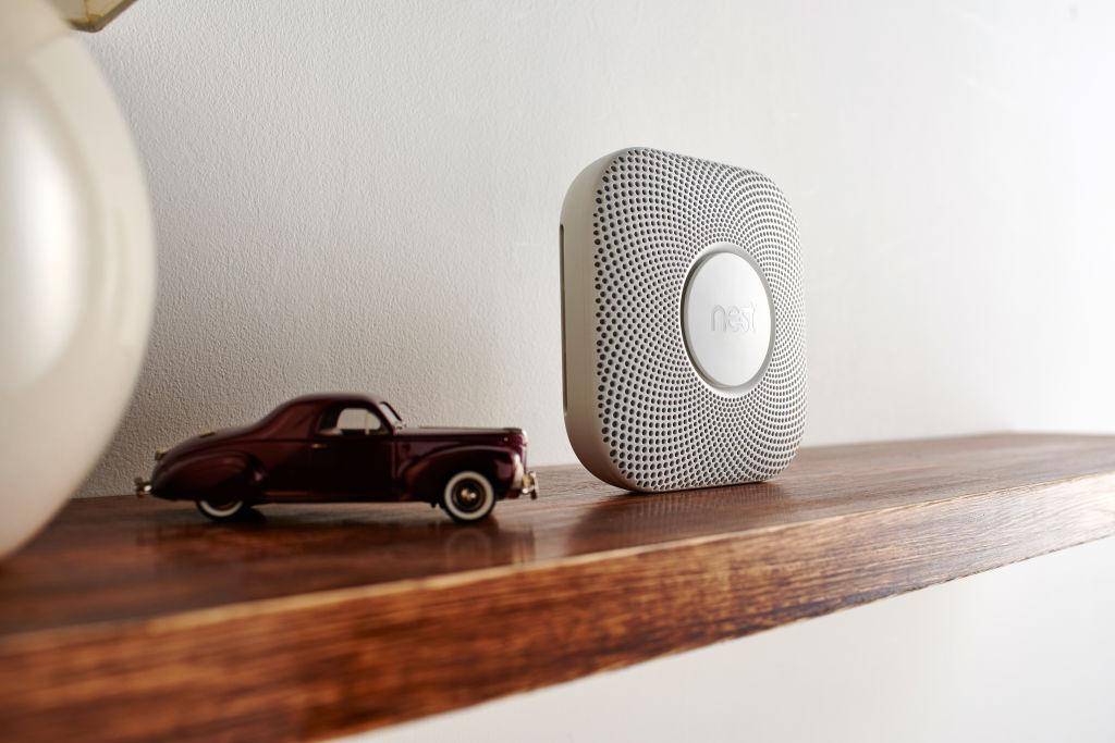 Toy car and electric on wooden shelf.