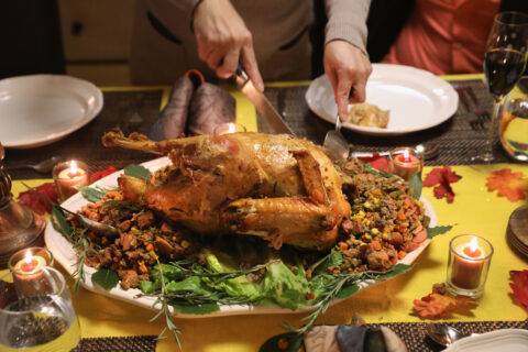 A Guatemalan immigrant carves the Thanksgiving turkey.