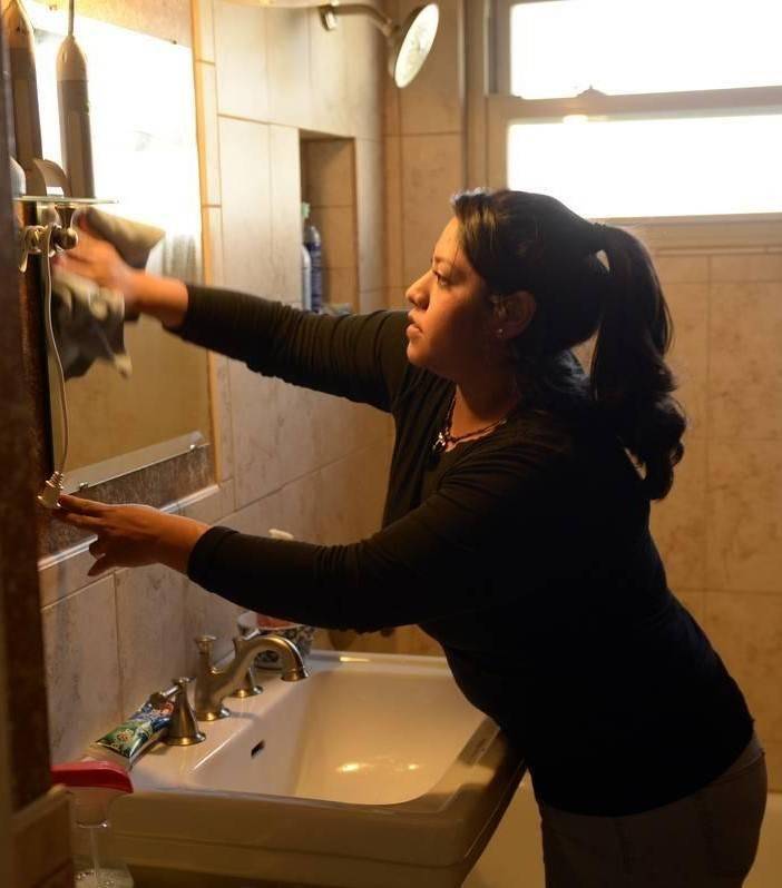 Woman cleaning glass.