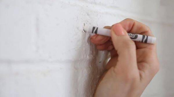 White crayon on wall.