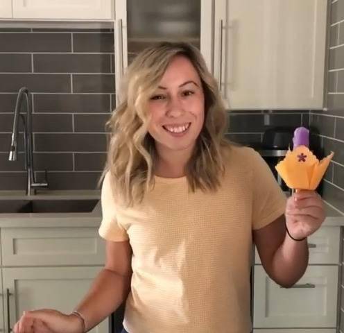 Woman holding a cupcake holder.