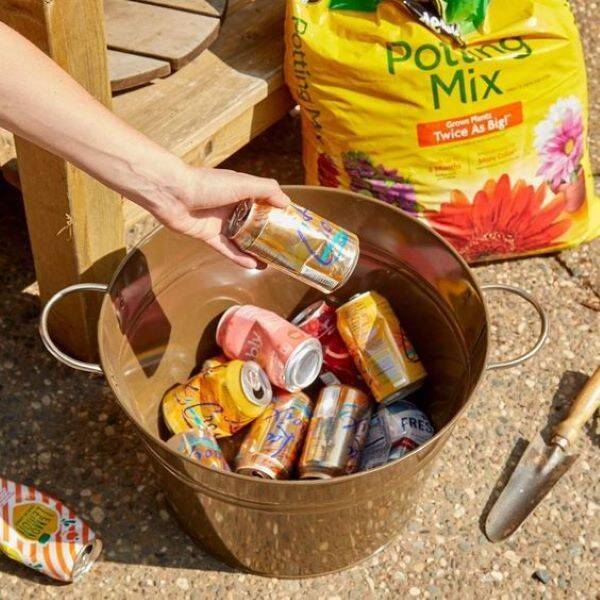 Soda cans in a bucket.