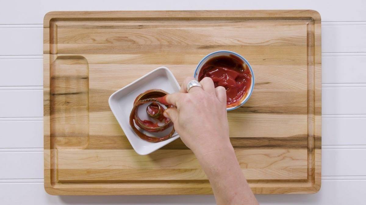 Ketchup on a cutting board.