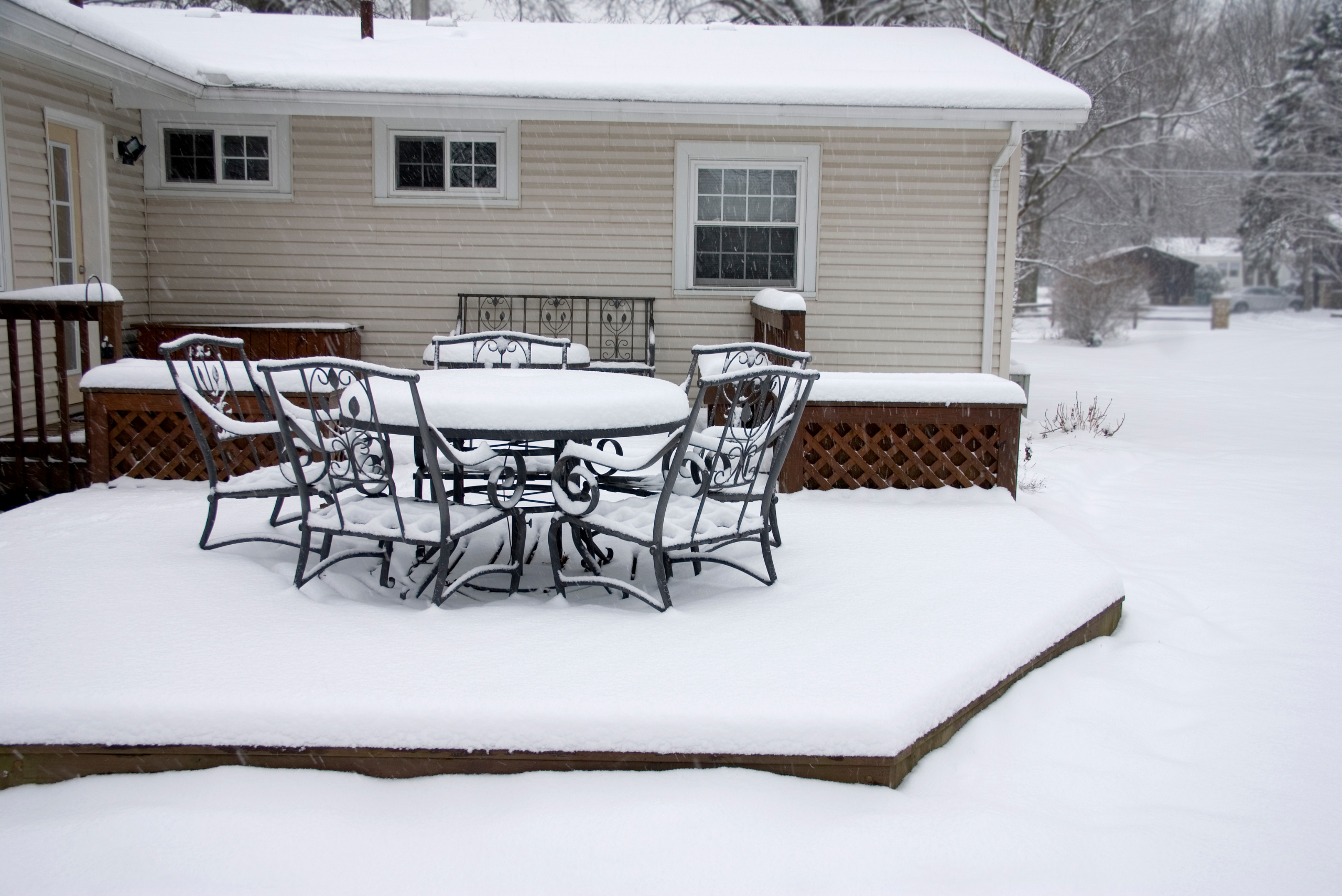 Outdoor furniture covered in snow.