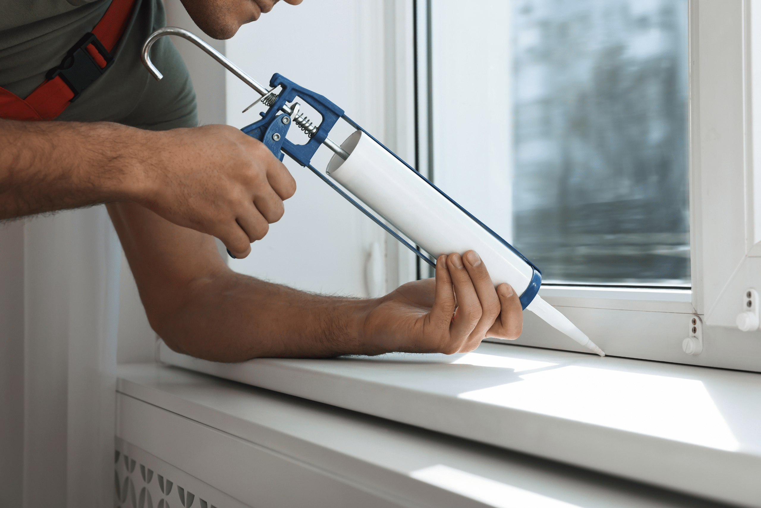 Caulking the gap between window and frame.