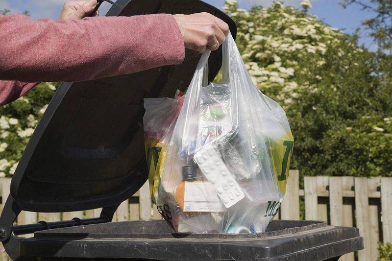 Woman throwing away trash