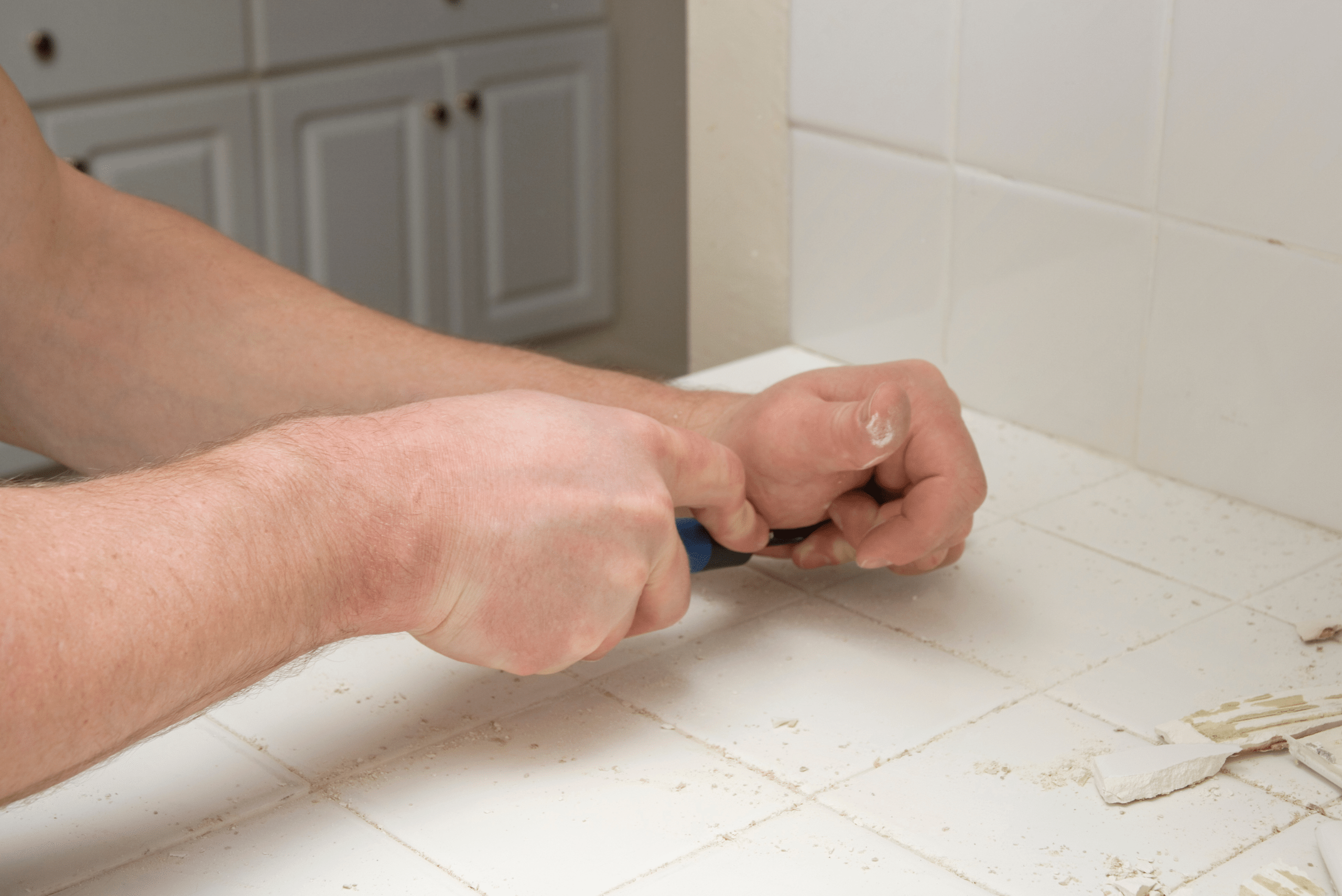 Scrubbing grout off bathroom floor.