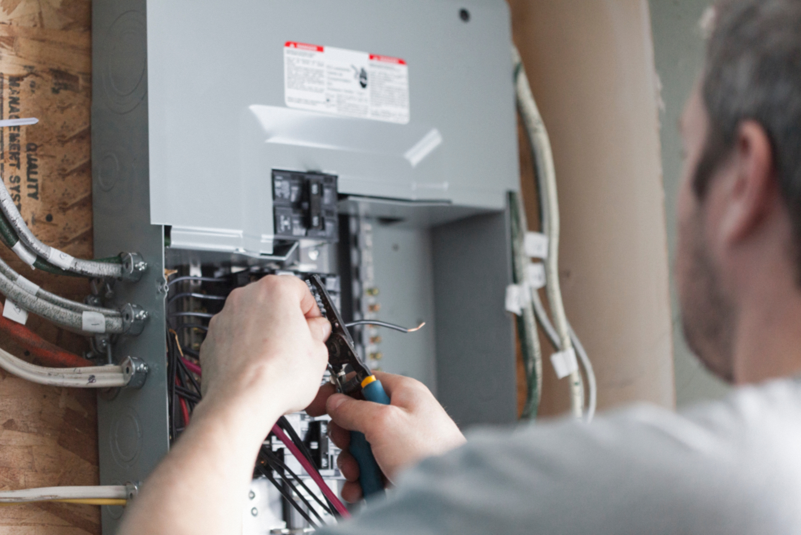 Electrician working on a breaker panel. 