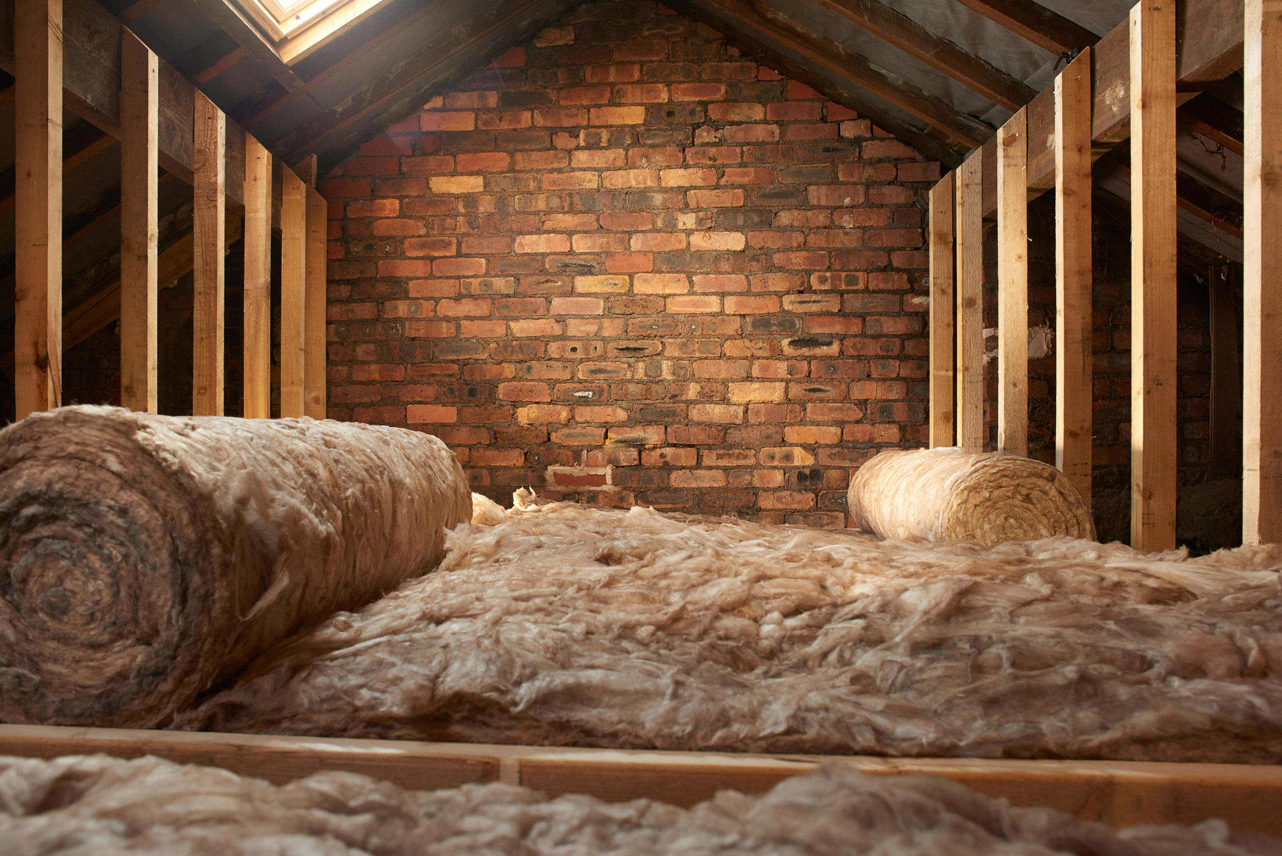 Attic with insulation on the floor rolled out.