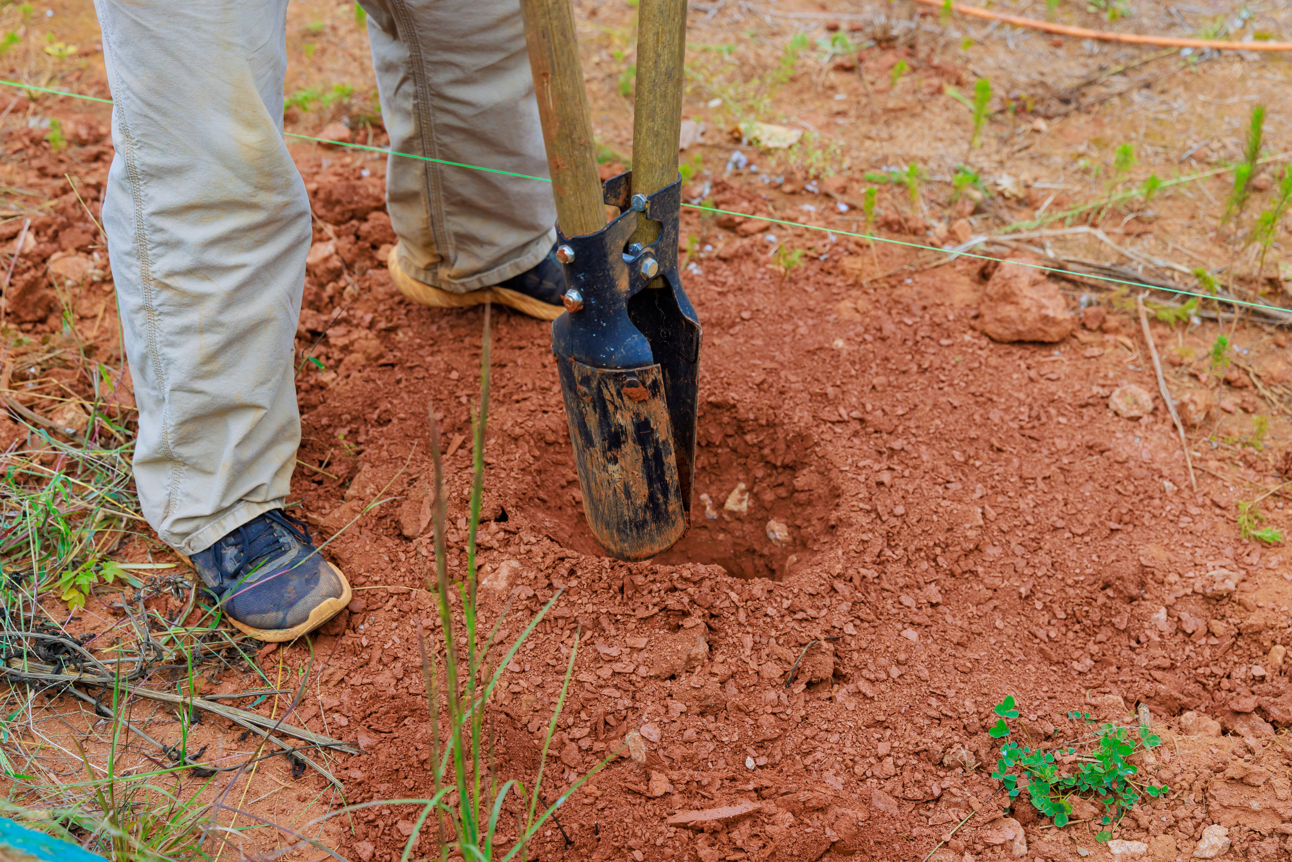 Digging a post hole.