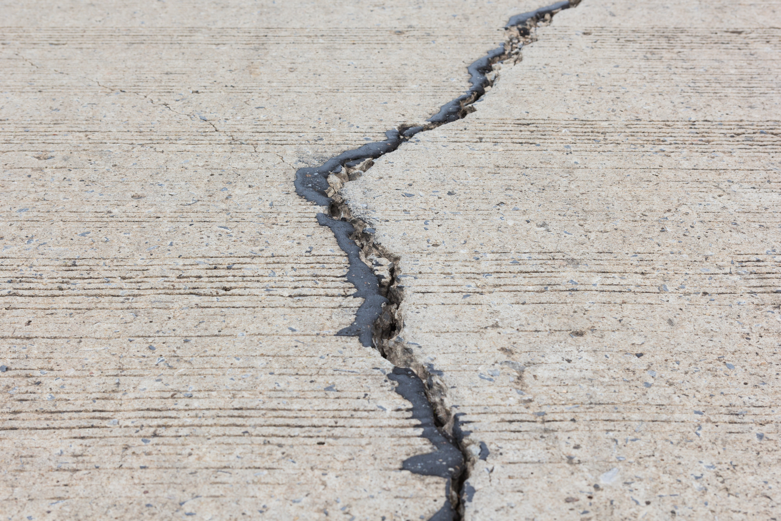 Sealed crack in a concrete driveway.