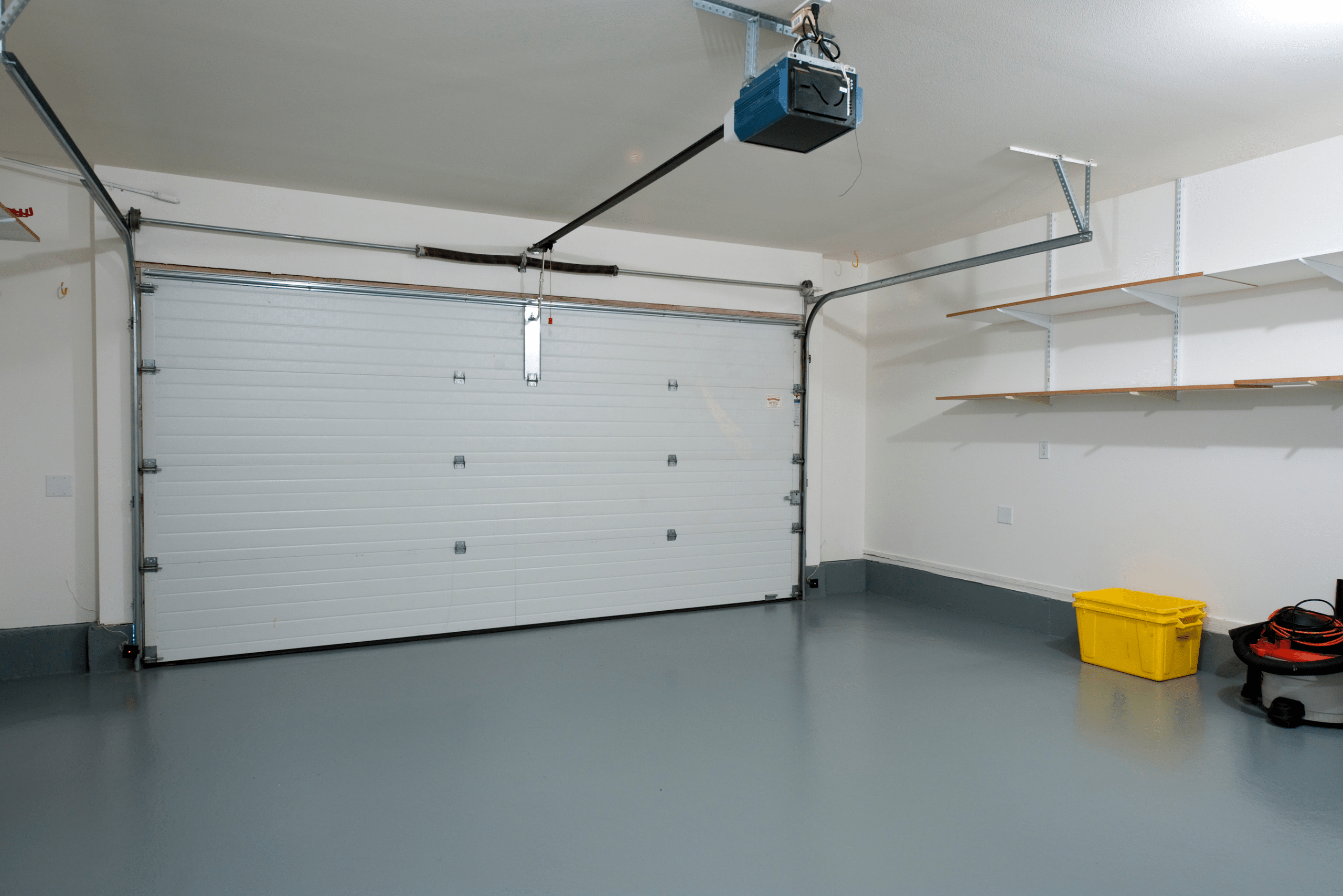 Empty garage with floating shelves.