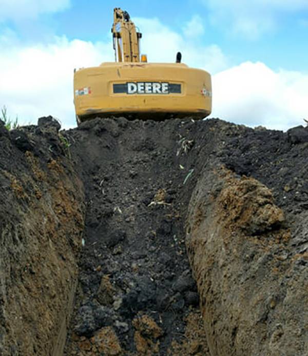 Heavy machine in front of dirt.