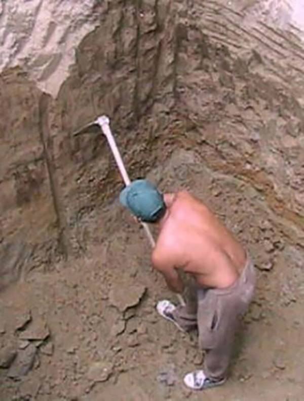 Man digging a hole.