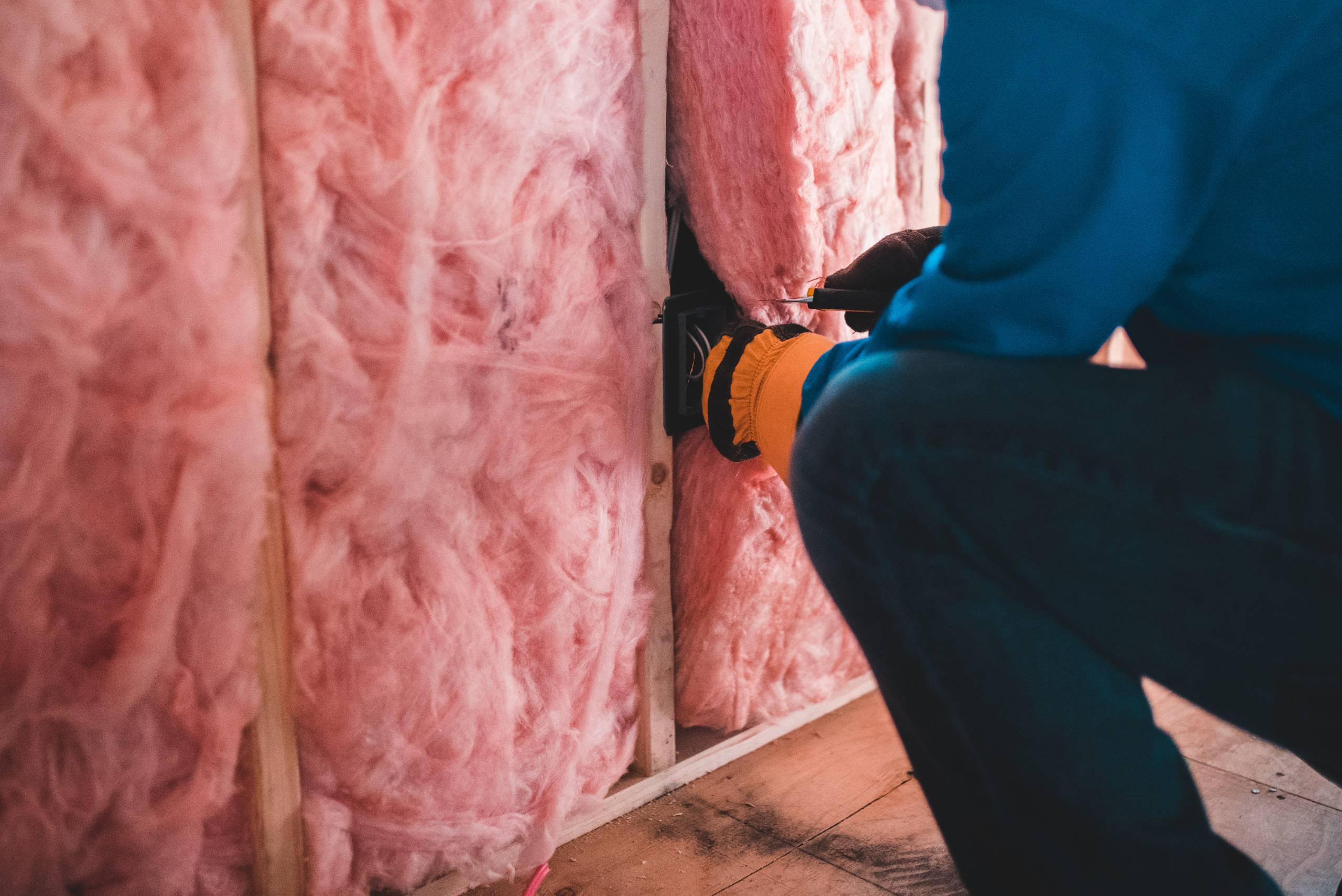 Worker installing insulation.