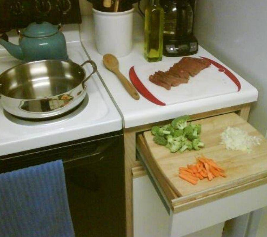 a drawer open with a cutting board on top