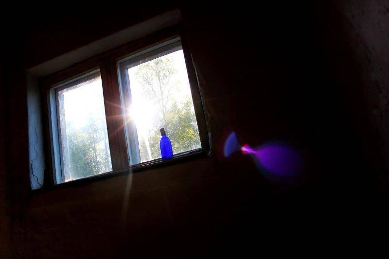 Sun shines through an open window into a dark room.