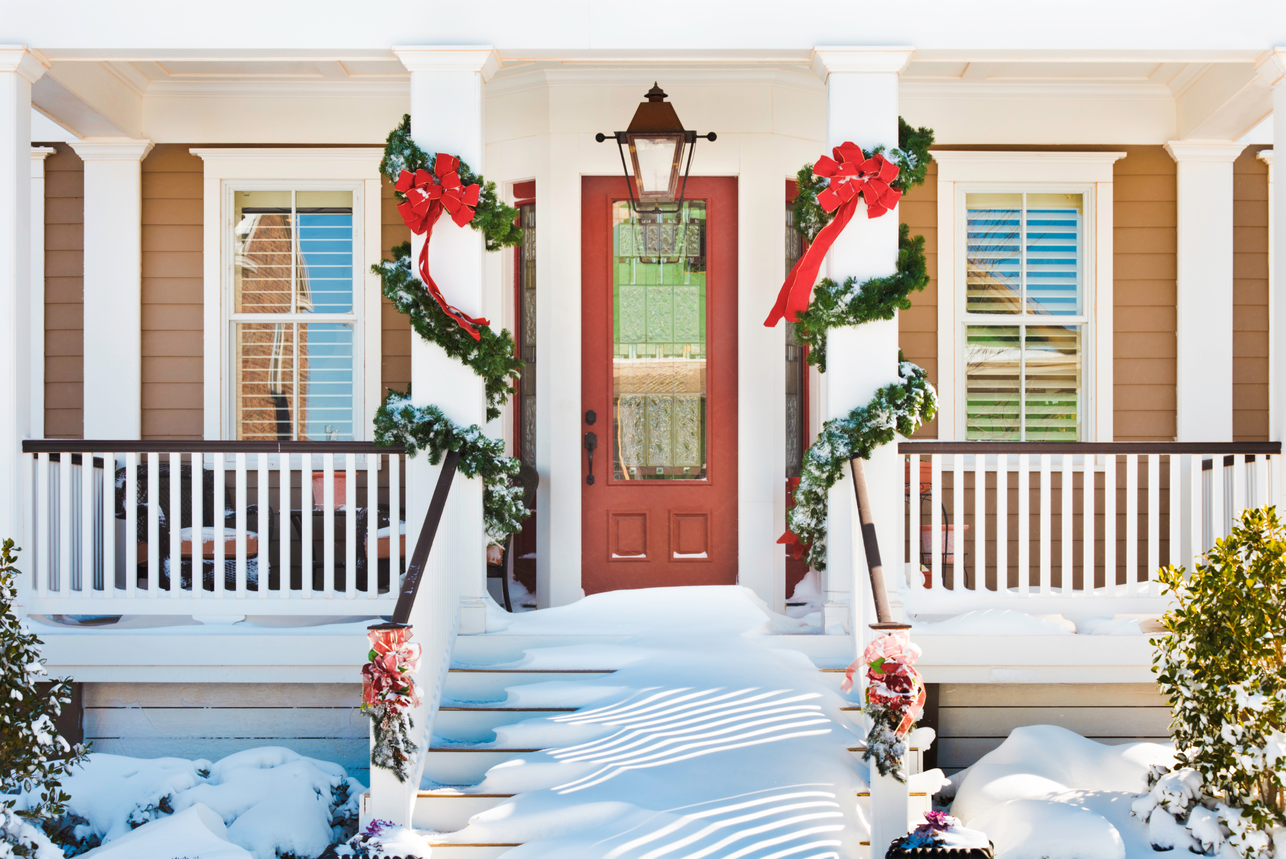 Snow on front stairs of a house.