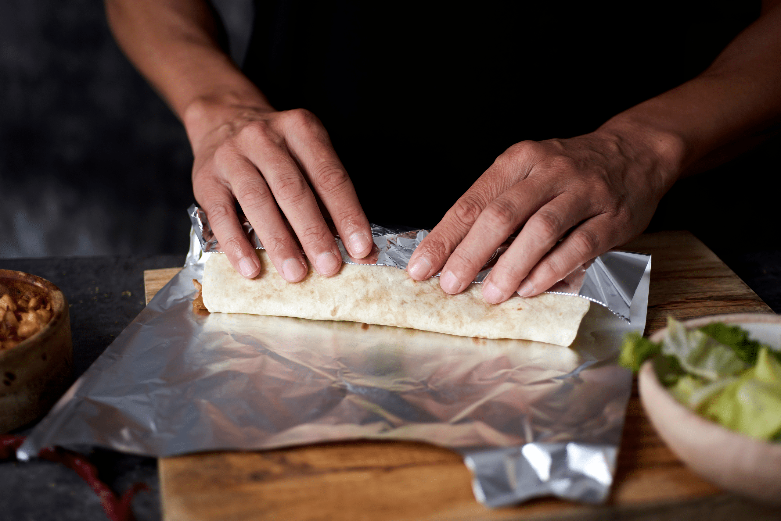 Wrapping food in tinfoil.