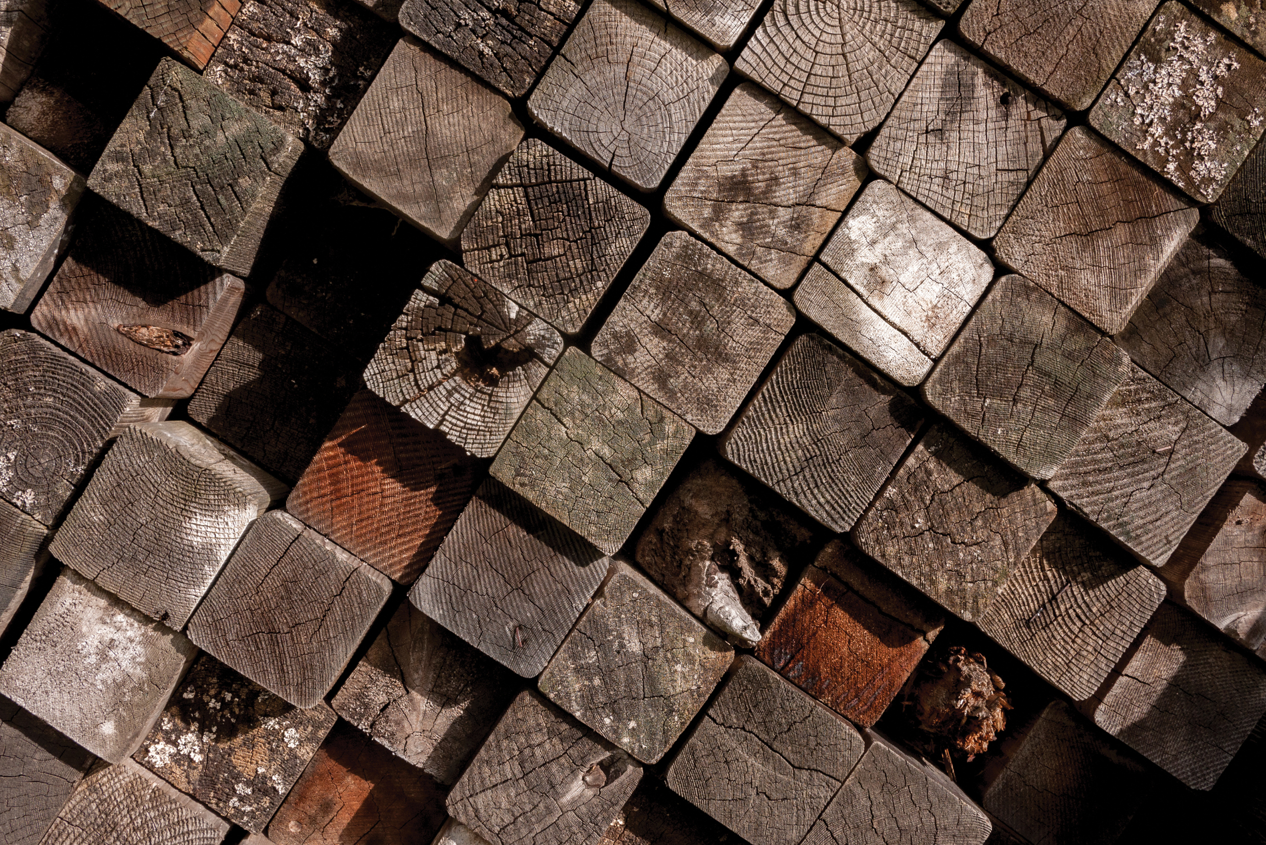 Stack of dirty 4x4 wood posts.