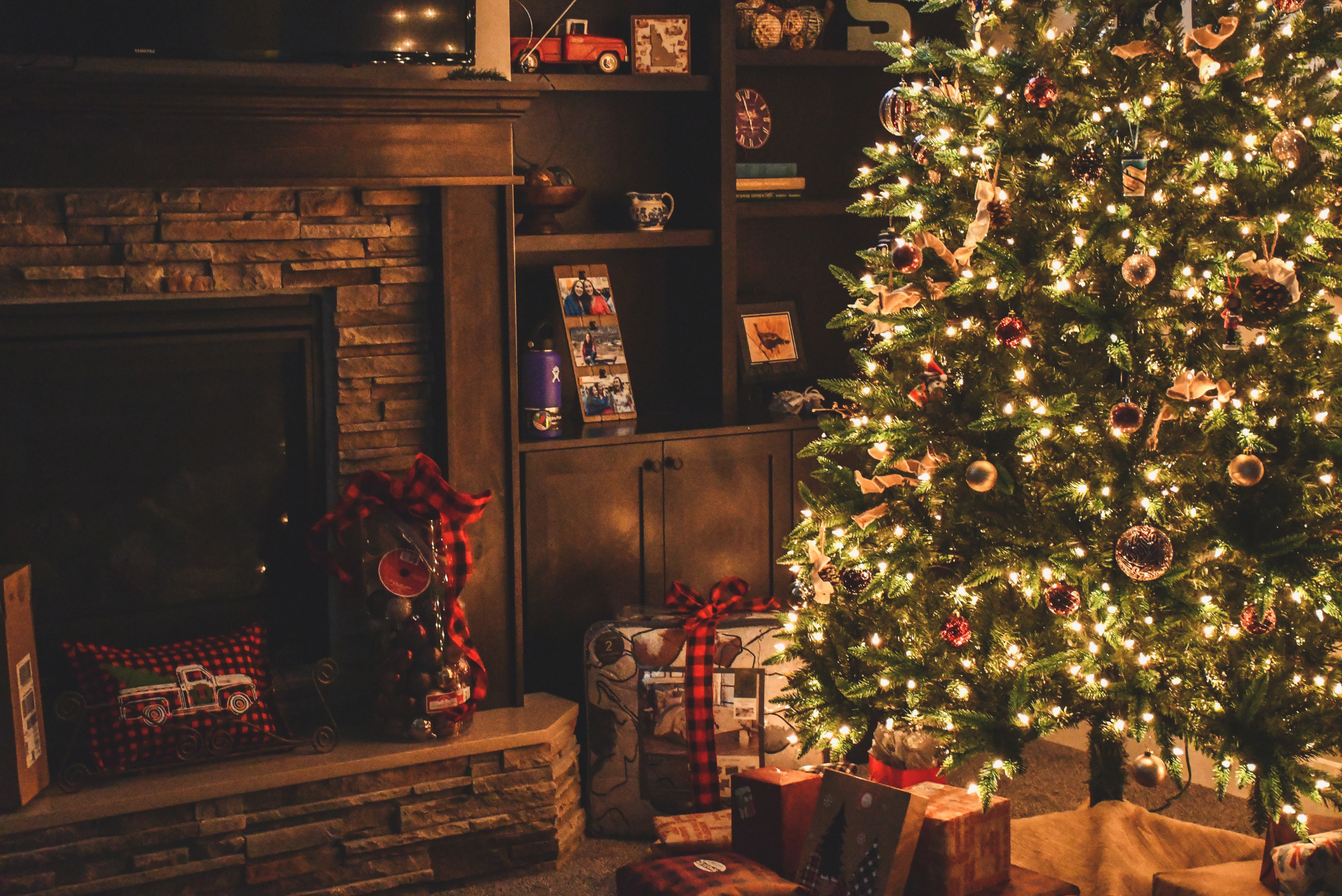 Lit up Christmas tree in a living room of a house.