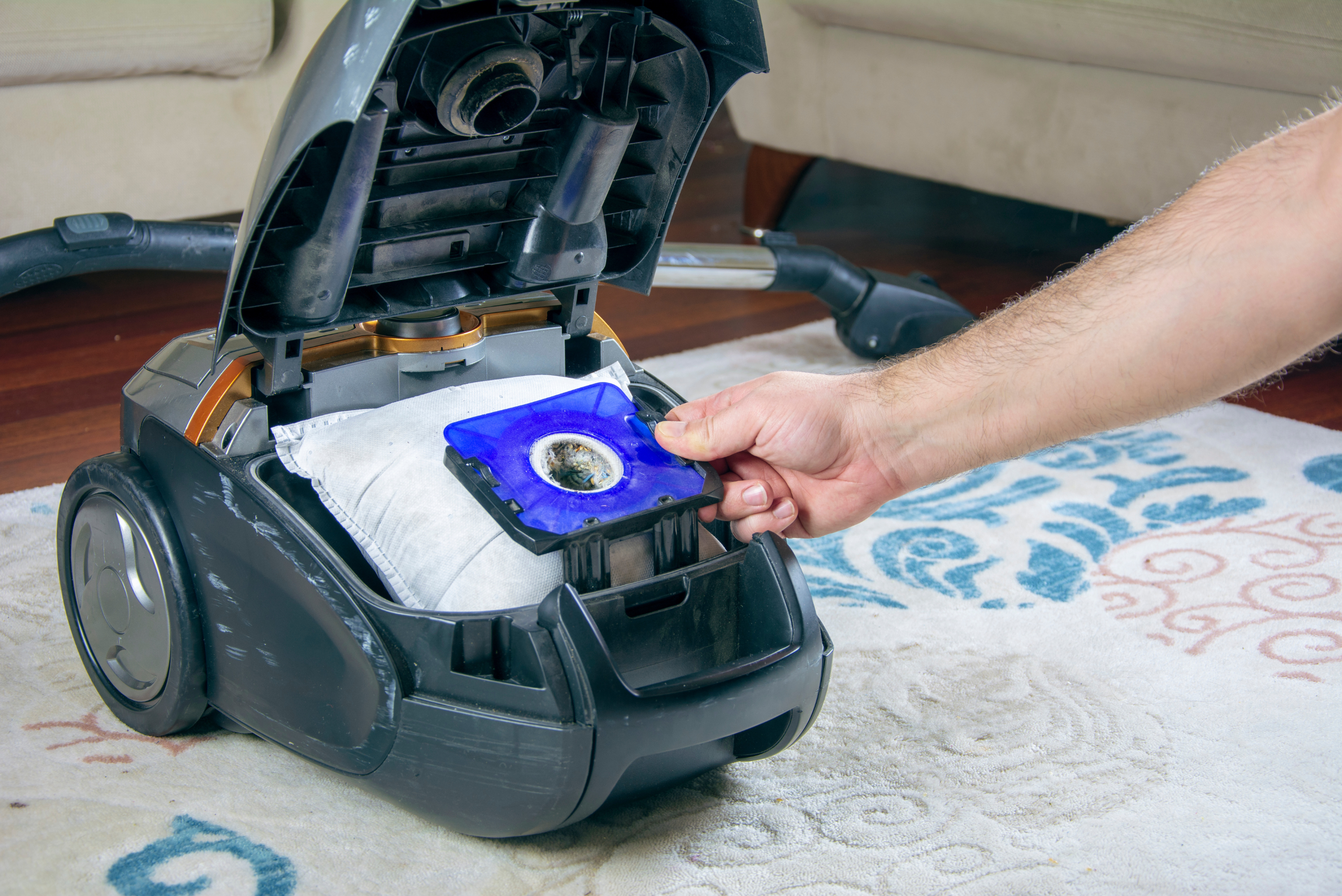 Removing dust bag of a vacuum.