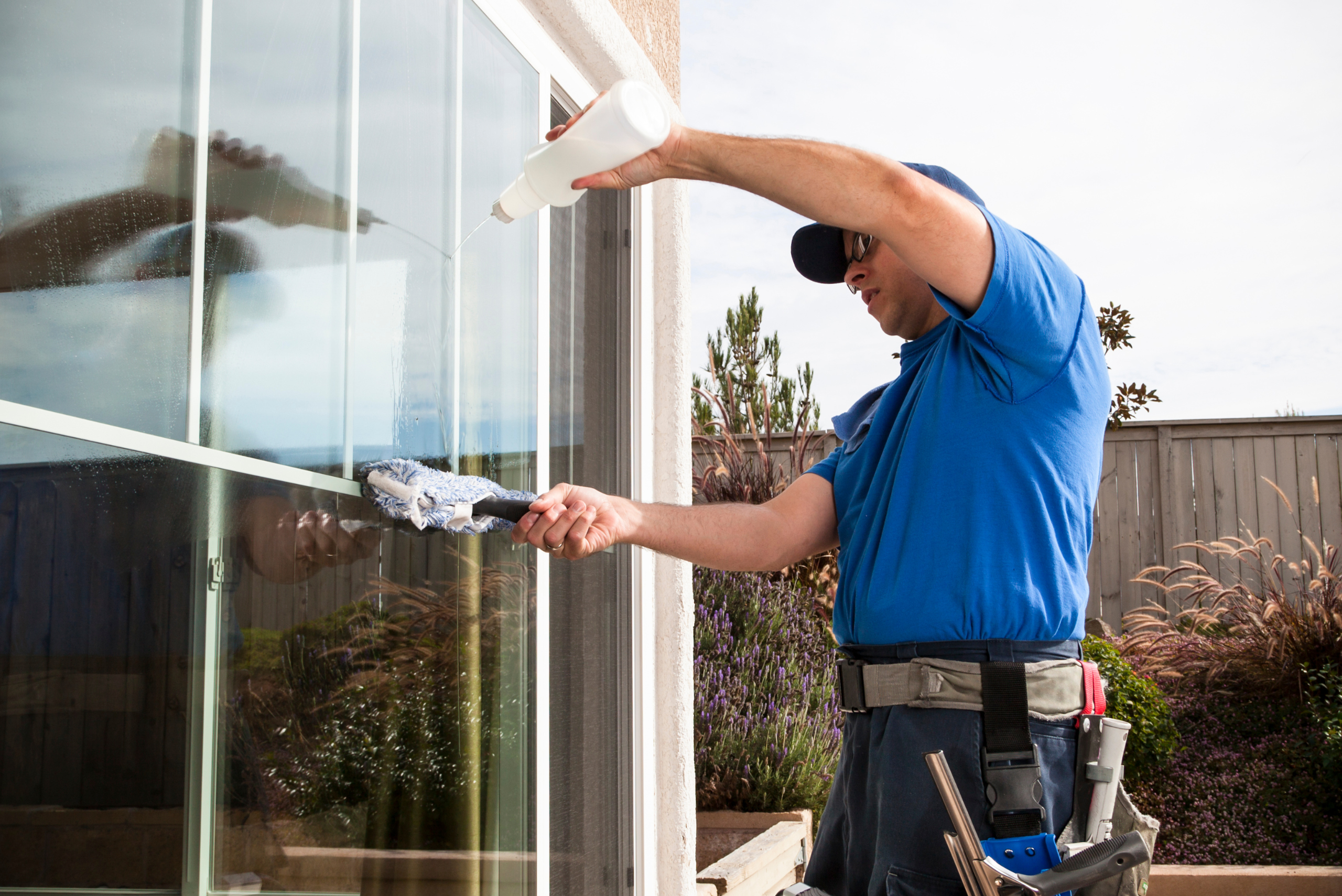 Cleaning exterior windows of a home.