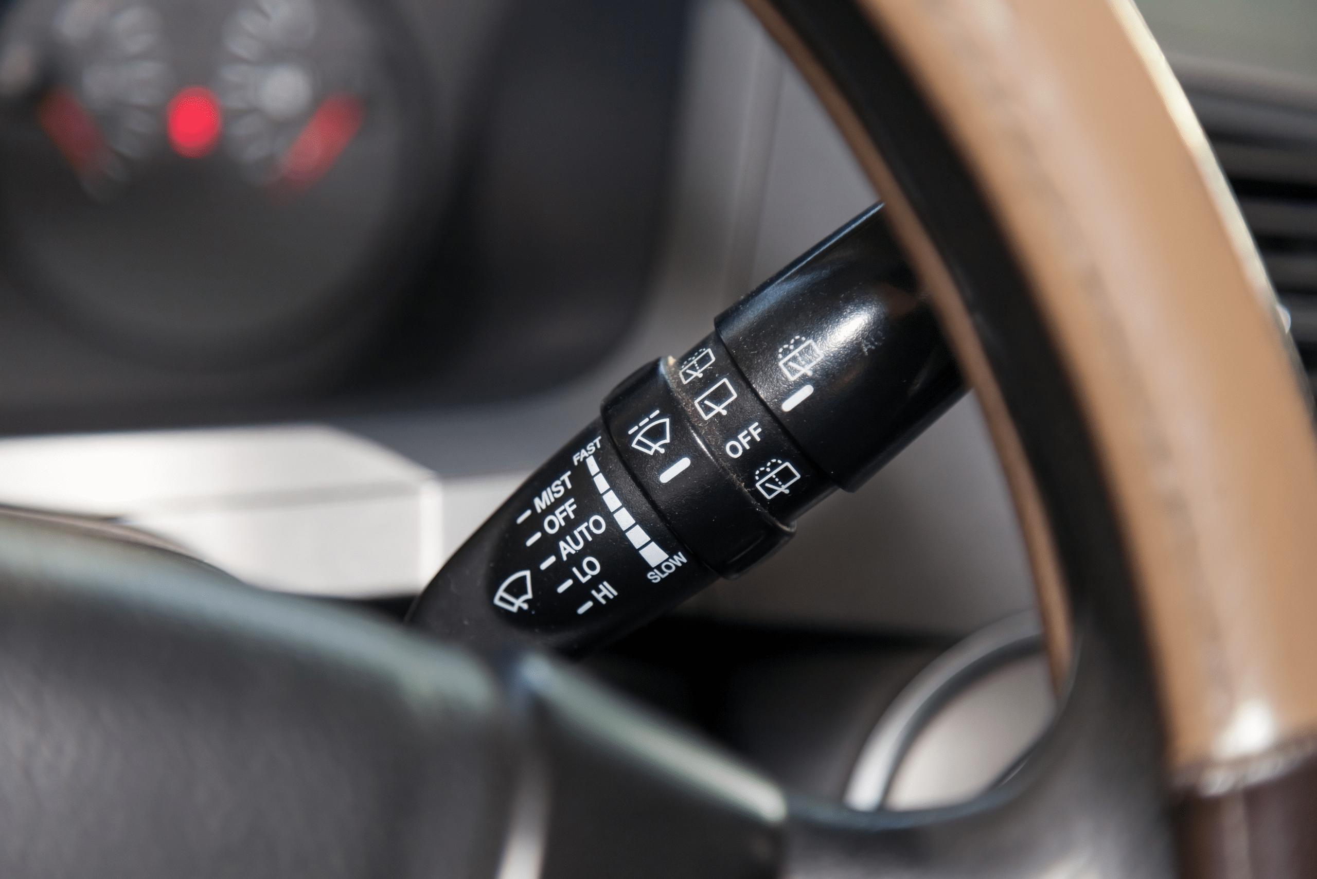 Closeup of the knob that controls the windshield wipers.