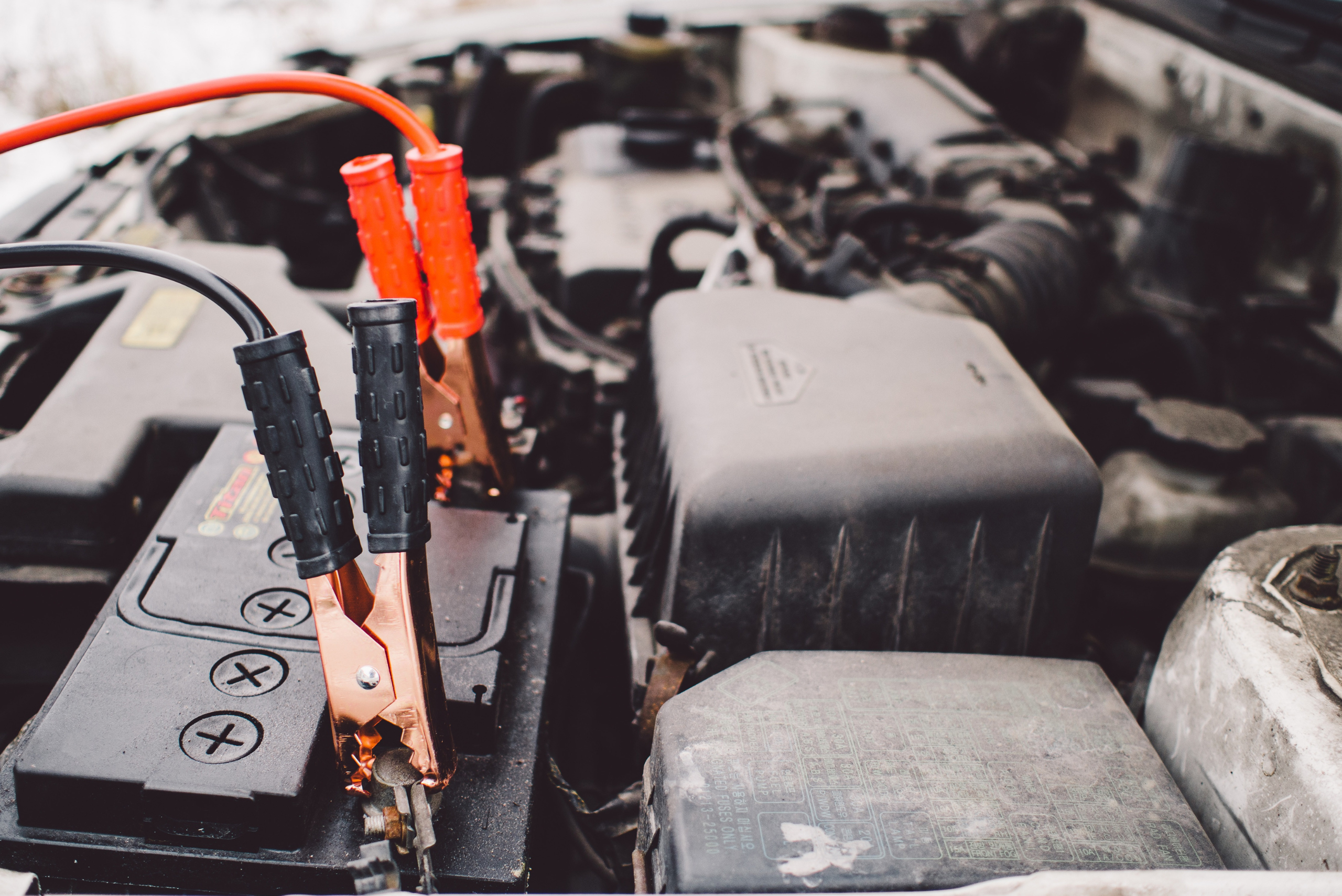 Car jumper cables attached to a battery.